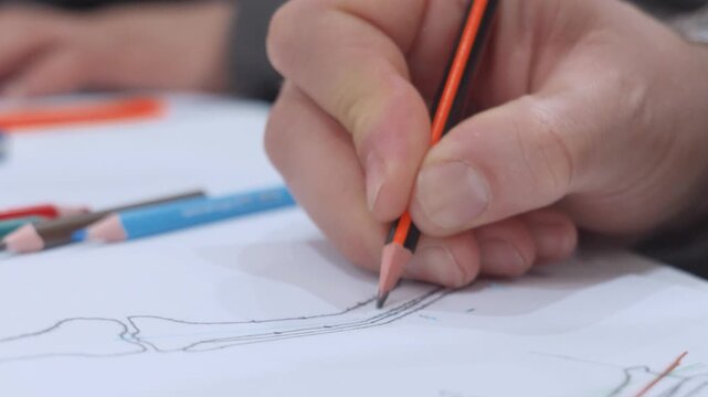 Close up of hand drawing bone anatomy diagram with pencil during surgical planning