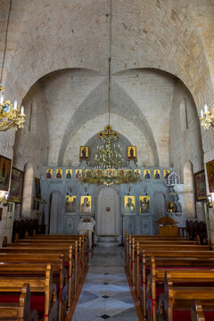 Wooden pews lead toward an ornate iconostasis inside the stone vaulted church of Our Lady of Nourieh Orthodox Monastery, North Governorate, Hamat, Lebanon