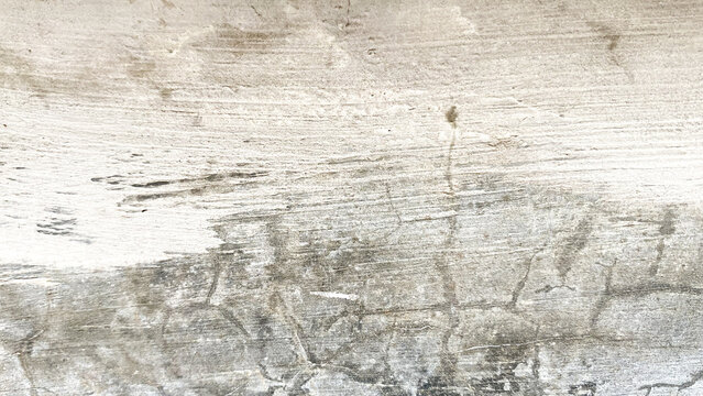 Weathered light grey concrete surface with horizontal dark scratches