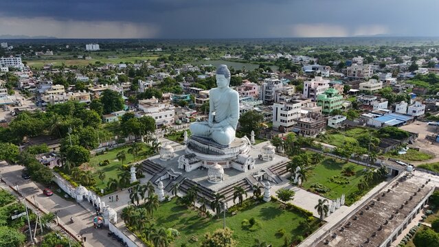 Aerial view of the Dhyana Buddha statue surrounded by lush gardens, pathways, and the urban landscape of Amaravati, Andhra Pradesh, India.