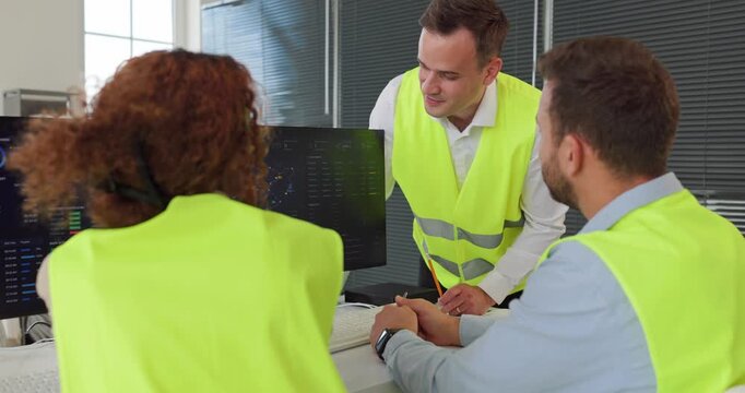Dispatchers team logistics monitoring computers dashboard office. Analysts control transport via realtime screens and maps, refining routes and deliveries. Clear logistics team plan concept.