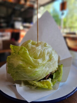 Burger wrapped in lettuce served on a plate