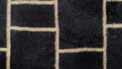 dark blue soft fleece blanket with beige brick pattern texture © Sabina Syalwa