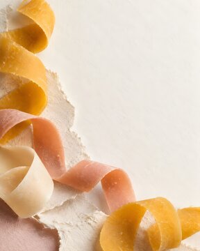 Golden beeswax curls on deckled paper with copy space