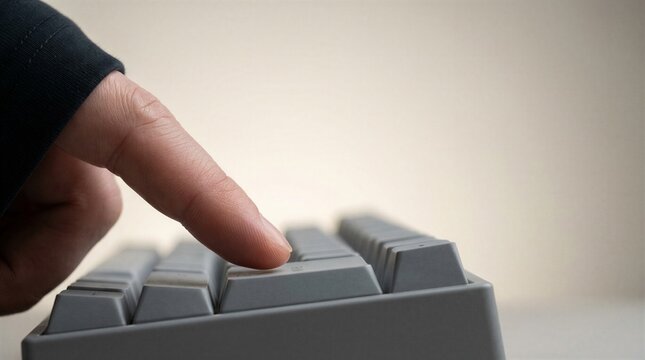 Macro view of finger about to press enter key on keyboard