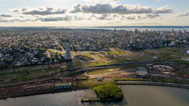Aerial view of the Argentina-Paraguay Customs area featuring modern infrastructure, surrounding urban cityscape, and the Parana River waterfront in Posadas, Misiones Province, Argentina.