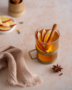 Hot apple cider with cinnamon and apple slices, autumn spiced drink