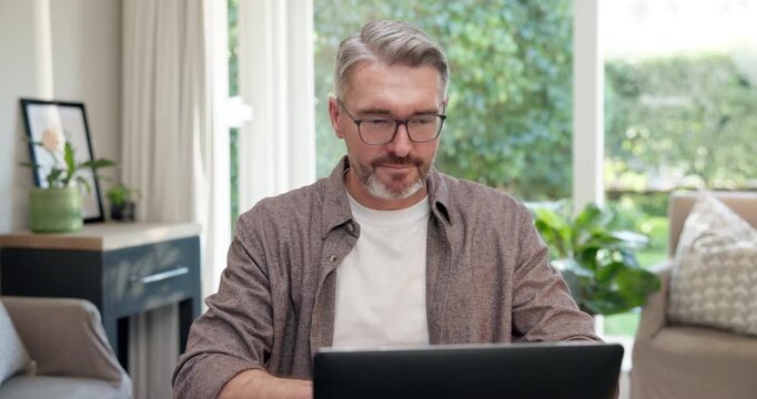 Remote work, document and man in home office with laptop, forecast and growth plan in finance review. WFH, digital or mature advisor with paper, budget outlook or reading report on revenue projection