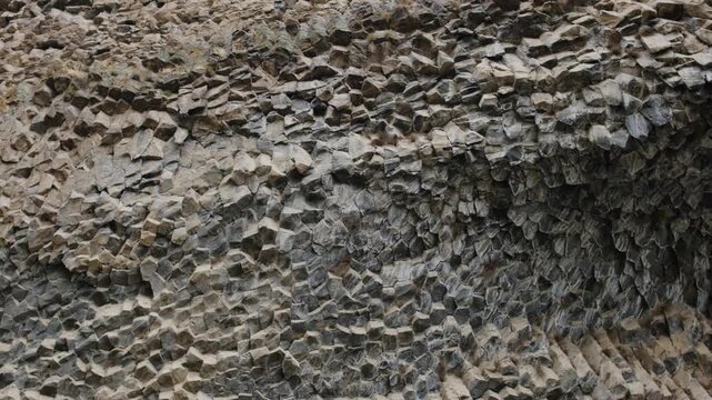 Symphony of Stones, Armenia. Geological formations display hexagonal basalt columns with intricate textures and patterns in a natural landscape, emphasizing the beauty of nature