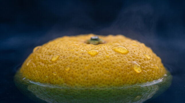 Macro of a yuzu fruit floating on steaming hot water