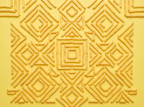 Flat Lay of French Fries in Geometric Pattern on Yellow Background seamless pattern with geometric pattern