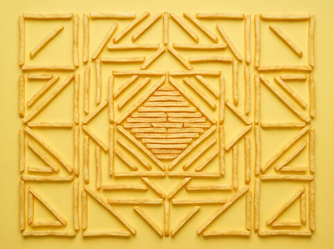 Flat Lay of French Fries in Geometric Pattern on Yellow Background seamless pattern with geometric pattern