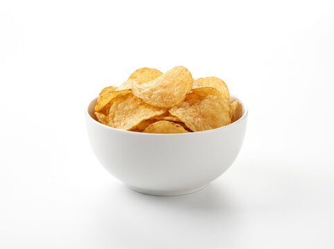 Crispy Potato Chips in green Ceramic Bowl on Pure White Background