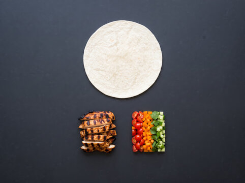 Top-Down Deconstructed Tortilla Wrap Ingredients on Dark Slate