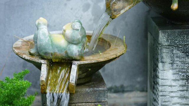 Ceramic figurine with fountain in the garden