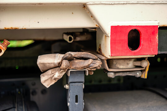 Used Work Gloves Resting on Truck Container Chassis Close Up Logistics and Heavy Transport