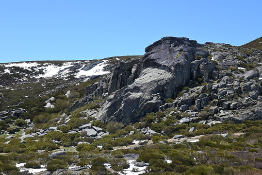 Rocky mountain ridge with snow patches near Laguna de los Peces in Sanabria
