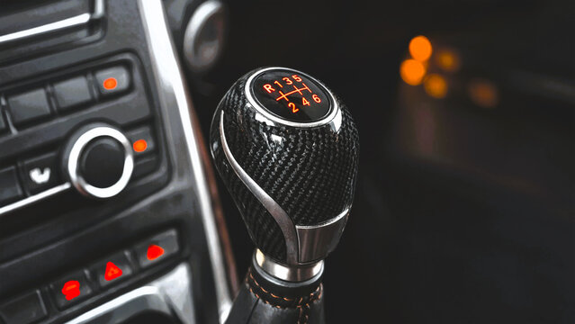 Carbon fiber manual gear shifter in a modern sports car interior