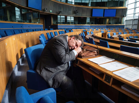 Fat politician sleeping in the plenary hall of the parliament