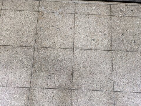 Weathered stone tile pavement texture with rectangular grid pattern