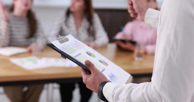 Business trainer giving lecture in meeting room, closeup