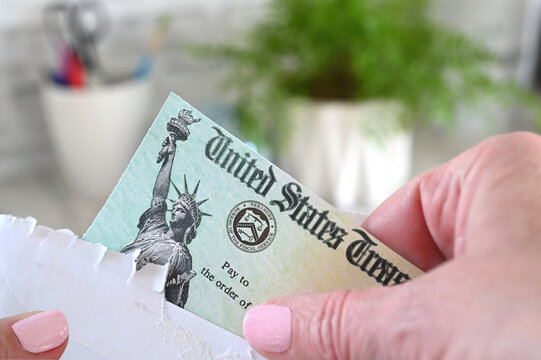 Holding a check from the United States Treasury