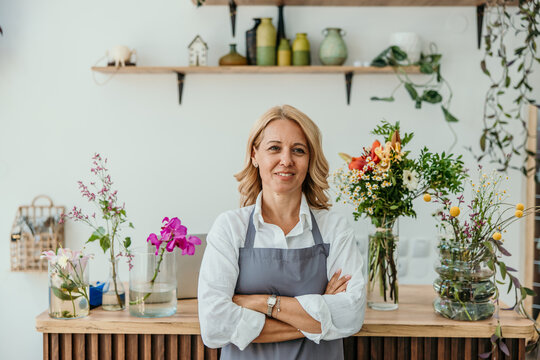 Smiling woman small business owner standing in flower shop