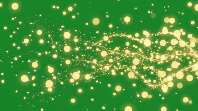 Golden glitter and sparkling threads floating across a green screen ba