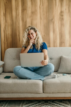 Young woman enjoying remote work on laptop at home