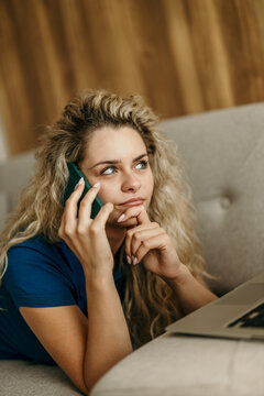 Woman working and talking on smartphone at home