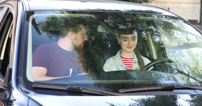 Driving school. Student and instructor shaking hands in car before lesson