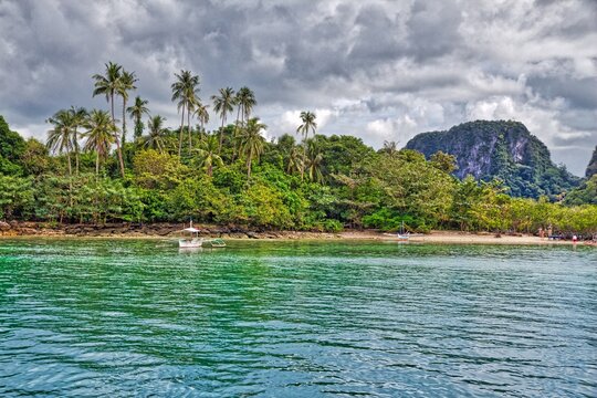 Natural landscape in Palawan island, Philippines. Snake Island with dramatic clouds.