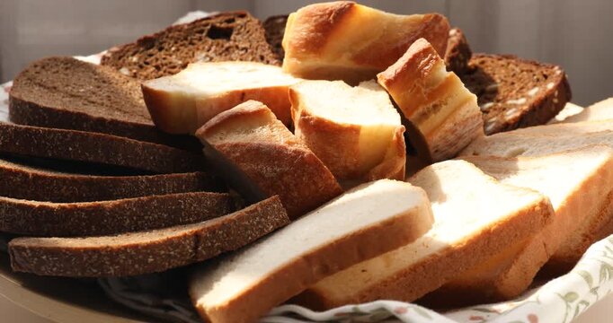 Different types of bread on table indoors, closeup. Camera moving in