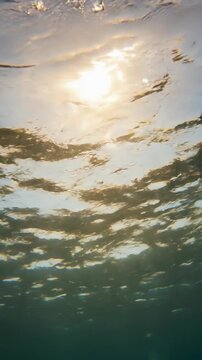 Water surface refraction timelapse shows light patterns on underwater lens while distorting images rapidly
