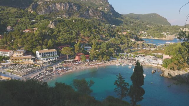 Looking down to the beach and bay of Paleokastritsa on the island of Corfu, Greece. Unidentifiable people bathing