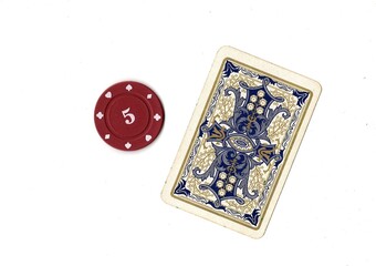 A vintage playing card and poker chip isolated on a white background. © Philip