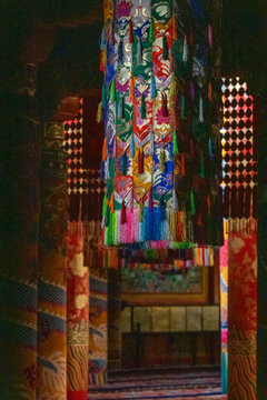 Ornate silk brocade decorations hanging inside Longwu monastery, Tongren County, Longwu, China