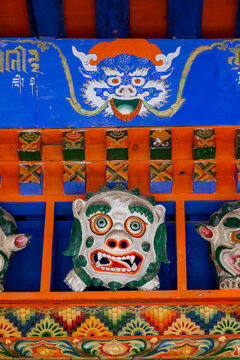 A carved dragon and lion motif adorn a painted beam at Bongya monastery, Qinghai Province, Mosele, China