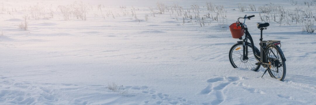 Winter bicycle in snow landscape with clear blue sky and open space