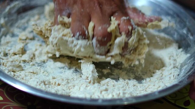 Close up of hands kneading chapati dough