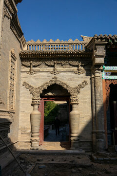 Carved stone vases flank a doorway at Dong Gong Guan mansion, Gansu Province, Linxia, China
