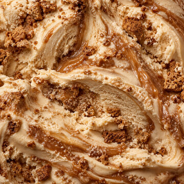 Vanilla ice cream with rich caramel swirl and crunchy cookie crumble in macro close up