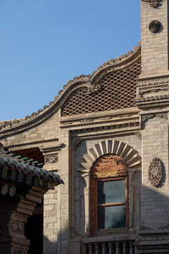 Ornate carved facade features a lattice window at Dong Gong Guan mansion, Gansu Province, Linxia, China