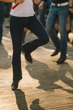 Solo Dancer Kicking Leg in Black Pants and Cowboy Boots At Sunset
