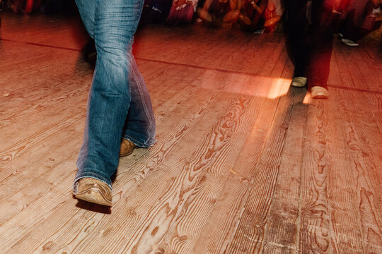 Line Dancers in Motion at Sunset on Wooden Floor