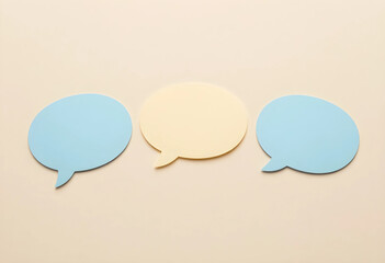 Obraz premium Communication and feedback concept, blank speech bubbles for social media messaging and customer service dialogue on a neutral beige background