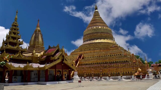 Bagan, Myanmar - March 15: Novice Buddhist monks walking around the sacred Shwezigon Paya, one of Myanmar's most revered pagodas, in Nyaung U, Bagan, Myanmar (Burma).BAGAN Burmese womans visit Shwezig
