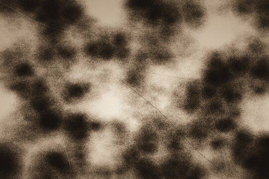 Contrast speckled vintage paper effect with dark charcoal spots on cream background suitable for artistic overlays and dramatic digital texture layers.