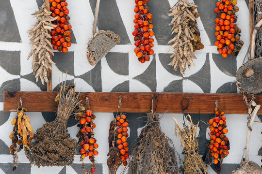Close up of geometric sgraffito wall decoration in Pyrgi with mediterranean herbs an dried tomatoes.