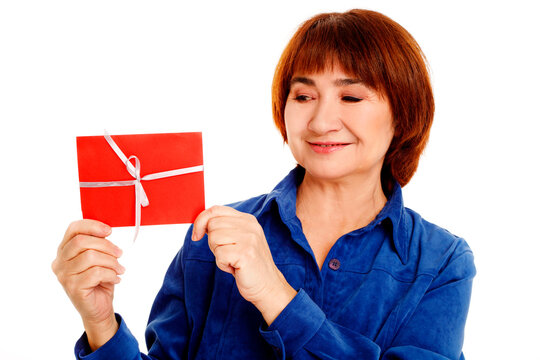 Senior woman holding red envelope gift with ribbon